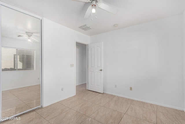 unfurnished bedroom with light tile patterned flooring, ceiling fan, and a closet