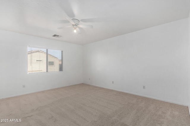 unfurnished room with light colored carpet and ceiling fan