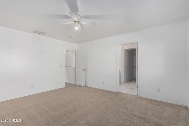 empty room with ceiling fan and light carpet