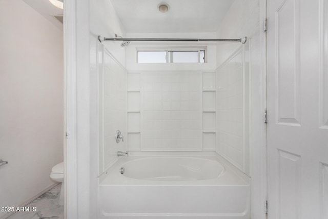 bathroom with shower / washtub combination and toilet