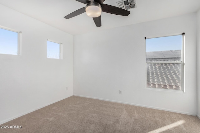 empty room featuring carpet floors and ceiling fan