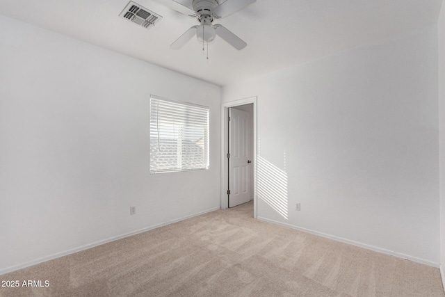 empty room with ceiling fan and light colored carpet