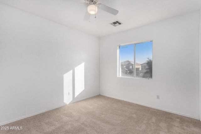 spare room with light colored carpet and ceiling fan