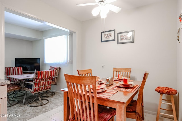 tiled dining room with ceiling fan