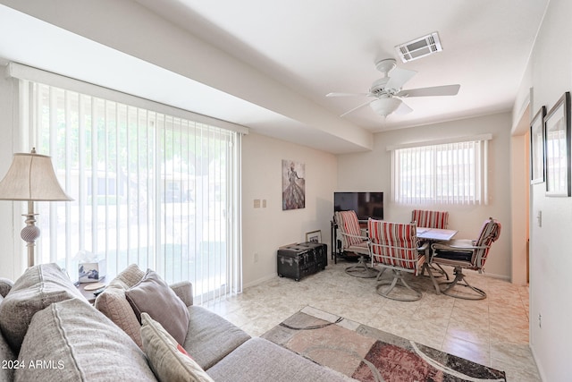 living room with light tile patterned flooring and ceiling fan