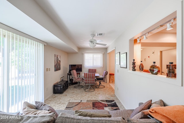 living room with ceiling fan, track lighting, and a wealth of natural light