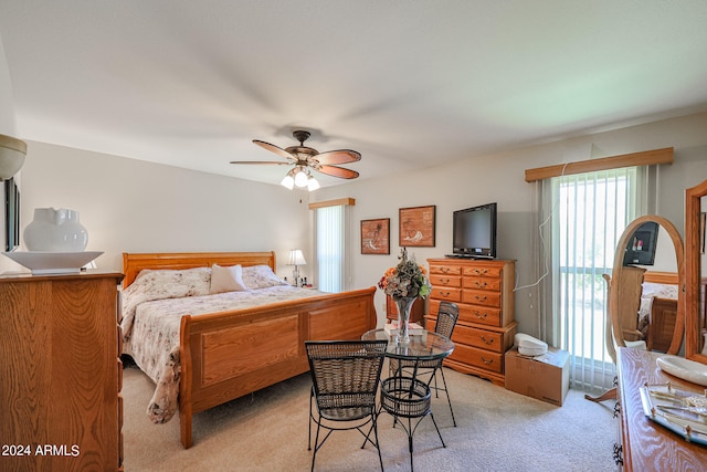 bedroom with light colored carpet and ceiling fan