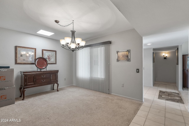 empty room featuring a notable chandelier and light colored carpet