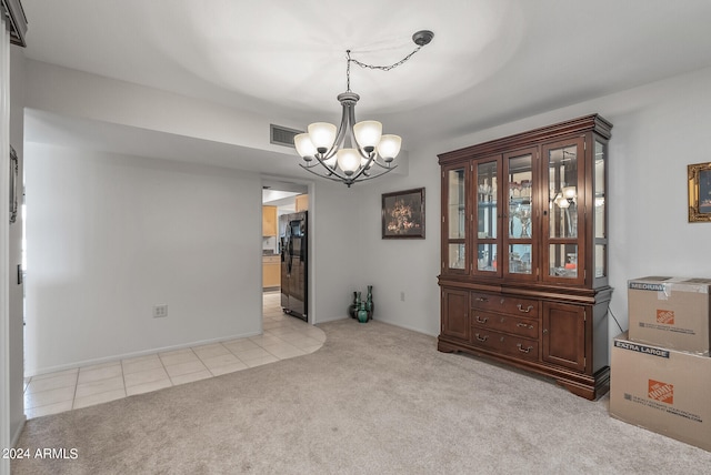 carpeted dining space with a notable chandelier