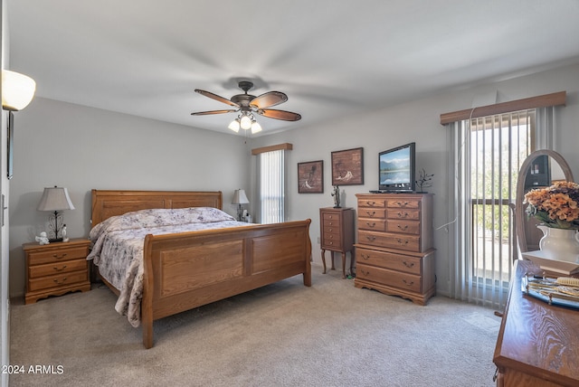 bedroom featuring light carpet and ceiling fan