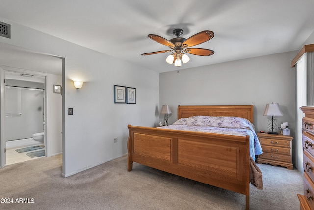 carpeted bedroom with connected bathroom and ceiling fan