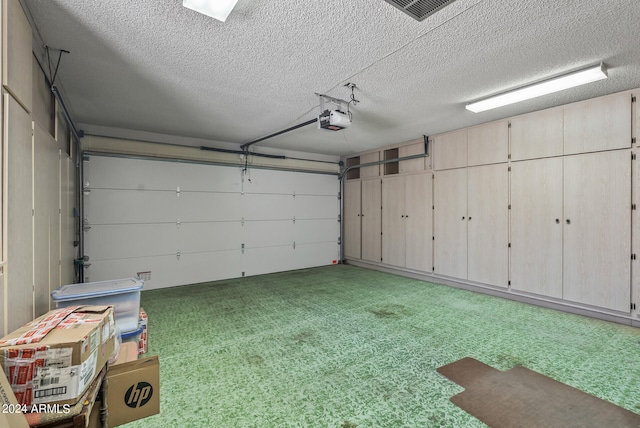 garage featuring a garage door opener and a lawn