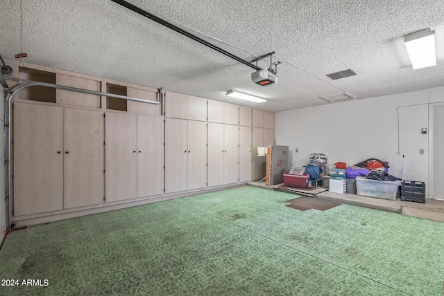 garage featuring a garage door opener and a yard