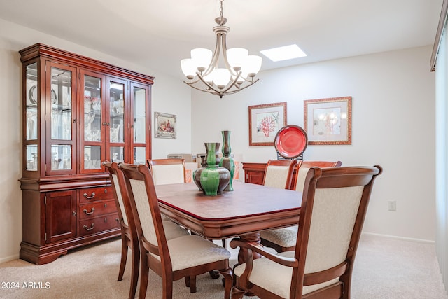 carpeted dining space featuring a skylight and a chandelier