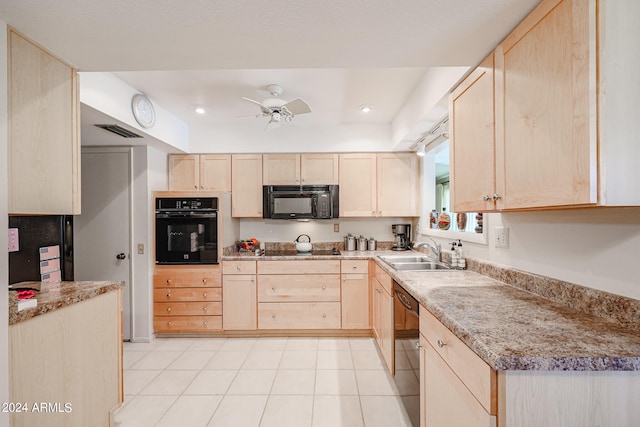 kitchen featuring light stone countertops, black appliances, sink, ceiling fan, and light brown cabinets