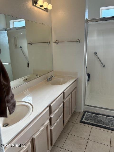 bathroom featuring tile patterned floors, vanity, and walk in shower