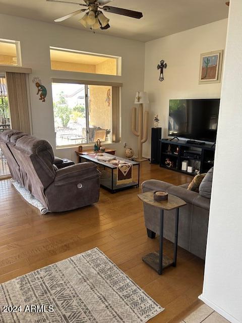 living room with hardwood / wood-style floors and ceiling fan