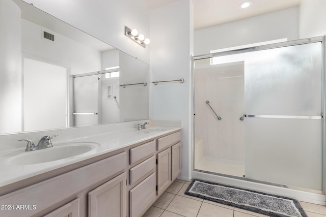 bathroom featuring vanity, tile patterned floors, and a shower with door