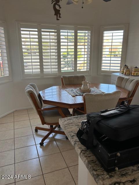 tiled dining space featuring ceiling fan