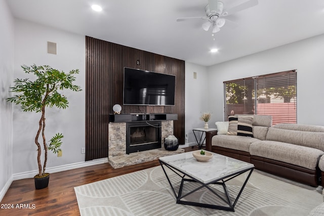 living room with hardwood / wood-style flooring, a fireplace, and ceiling fan