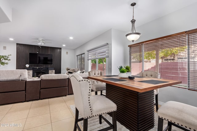 tiled dining space with ceiling fan