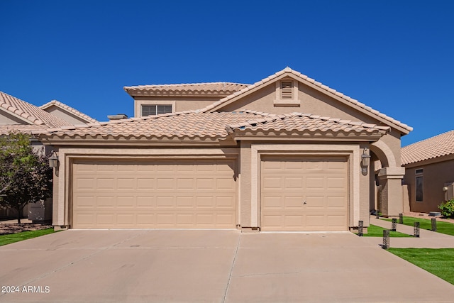 mediterranean / spanish-style home featuring a garage