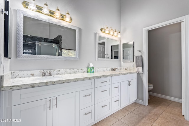 bathroom featuring an enclosed shower, vanity, tile patterned flooring, and toilet