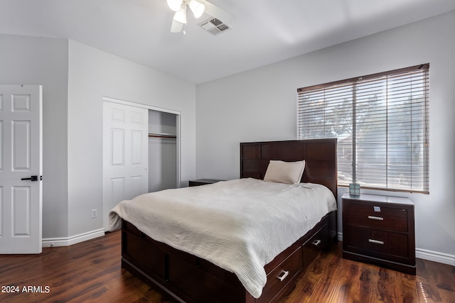 bedroom with a closet, dark hardwood / wood-style floors, and ceiling fan