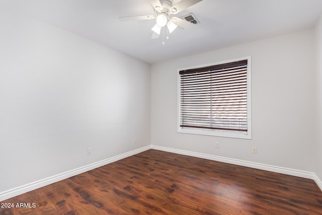 unfurnished room with ceiling fan and dark hardwood / wood-style flooring