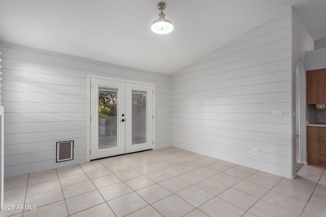 spare room featuring vaulted ceiling and french doors