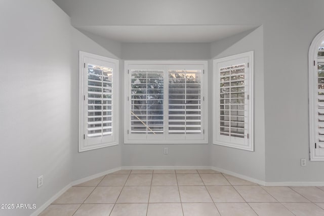 tiled spare room with baseboards