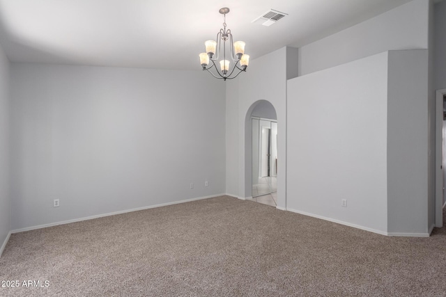 empty room featuring baseboards, visible vents, an inviting chandelier, arched walkways, and light colored carpet