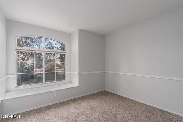 unfurnished room featuring baseboards and carpet floors