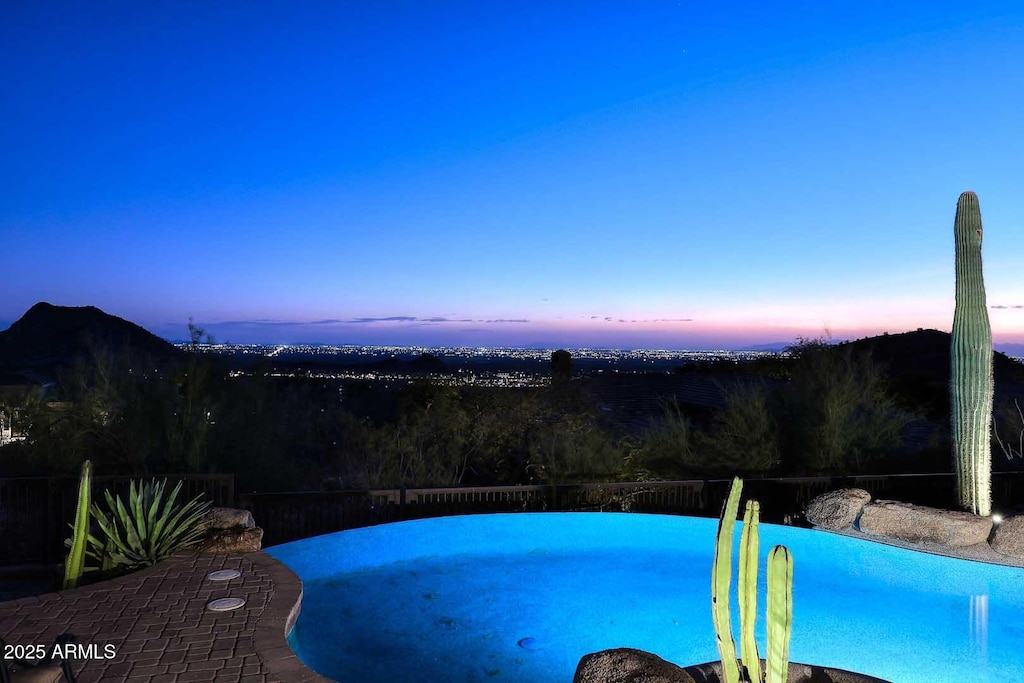 view of pool at dusk