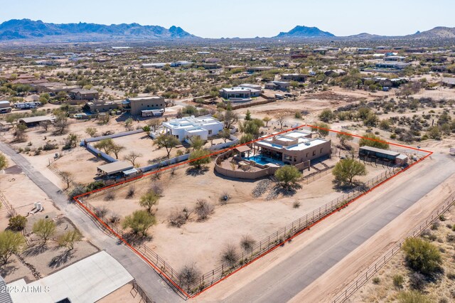 drone / aerial view with a mountain view and view of desert