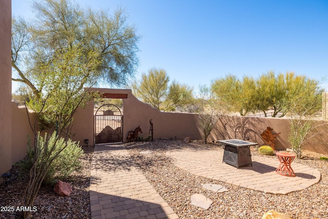 view of patio with a fenced backyard and a gate
