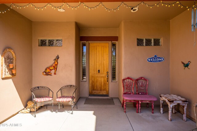 view of exterior entry with stucco siding