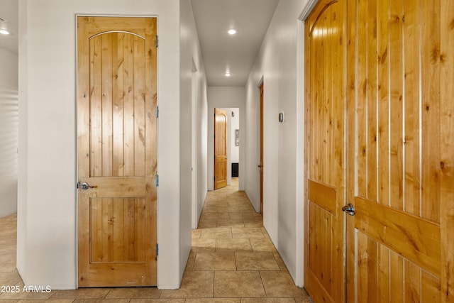 hall featuring baseboards and recessed lighting