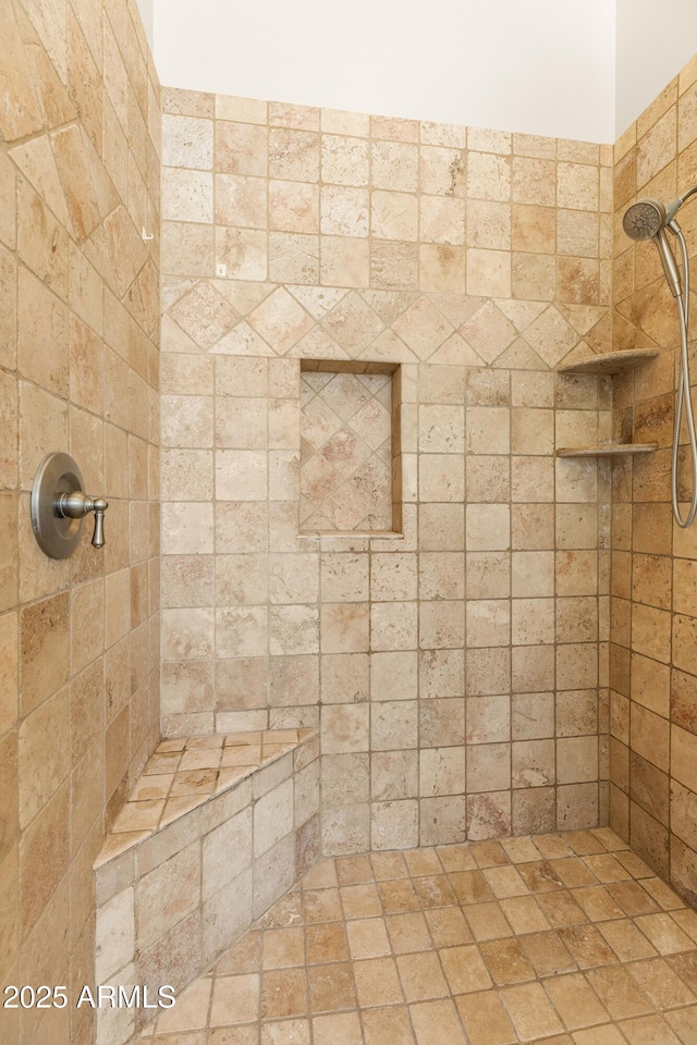 full bath with a tile shower