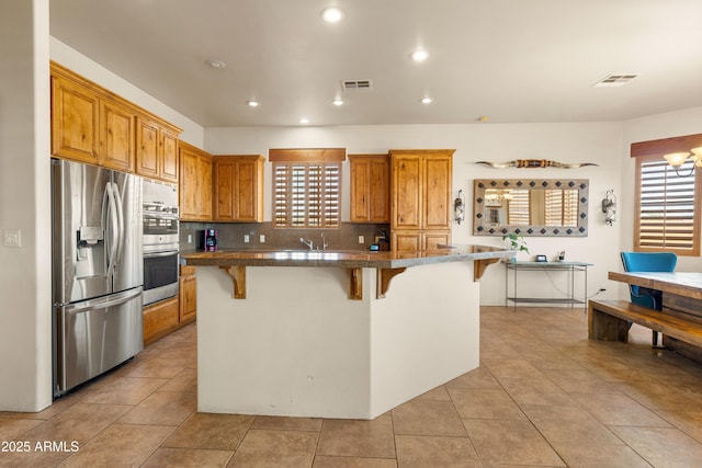 kitchen featuring a healthy amount of sunlight, stainless steel appliances, and visible vents