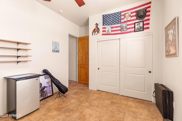 bedroom with ceiling fan and a closet