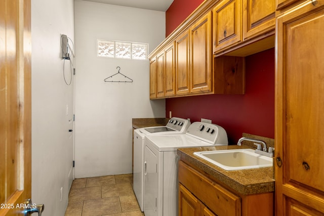 clothes washing area with washer and clothes dryer, a sink, and cabinet space