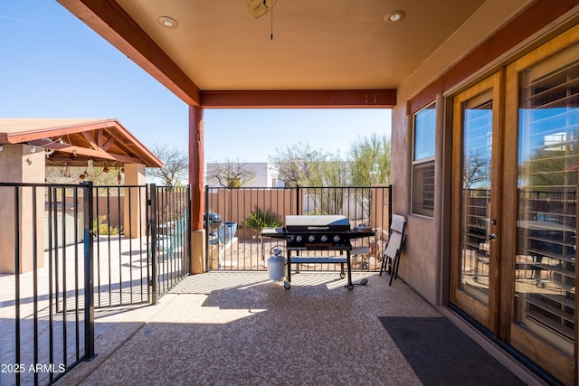 view of patio featuring fence, a gate, and area for grilling
