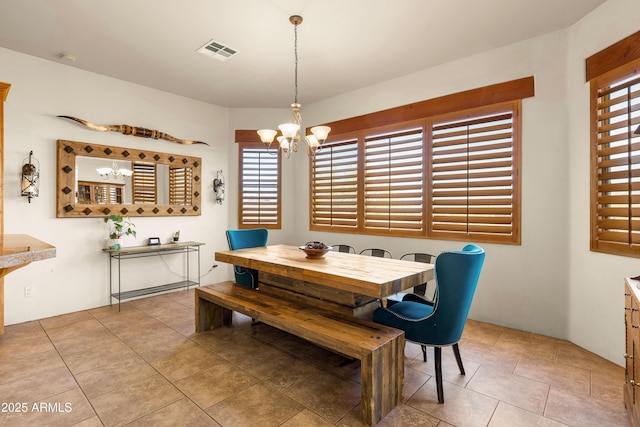 dining room with a chandelier, visible vents, and light tile patterned floors