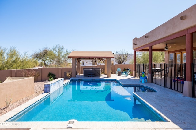 view of pool featuring a patio area, a fenced backyard, a hot tub, a fenced in pool, and ceiling fan
