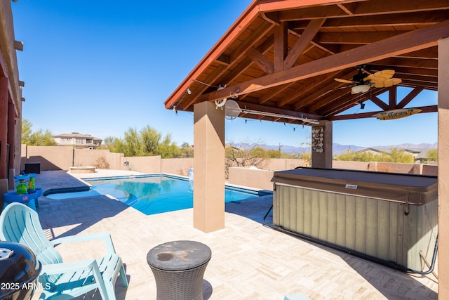 view of pool with a ceiling fan, a fenced in pool, a fenced backyard, a patio area, and a hot tub