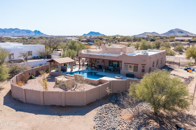 view of swimming pool with a fenced backyard, a mountain view, a patio area, and a gazebo