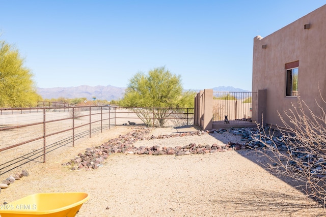 view of yard with a mountain view, fence, and a sink
