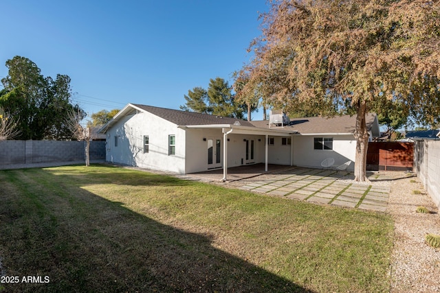 back of house featuring a yard and a patio