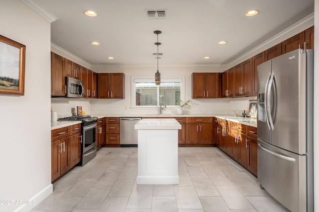 kitchen featuring sink, decorative light fixtures, ornamental molding, a kitchen island, and appliances with stainless steel finishes